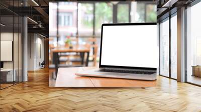 Laptop computer on wooden table with empty screen. Wall mural