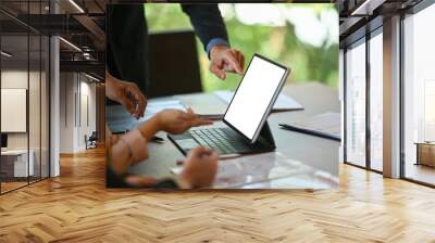 Two businesspeople discussing business data on computer tablet and discussing business ideas together. Wall mural