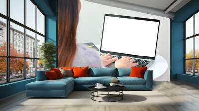 young woman's typing laptop computer, Mockup blank screen with behind photo shot. Wall mural