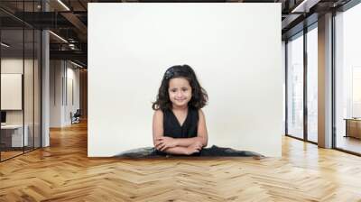  A delightful little girl with sparkling eyes, breaking into a wide, infectious smile. Her expression radiates pure happiness and innocence. Wall mural