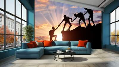 Men climbers help each other in the mountains Wall mural