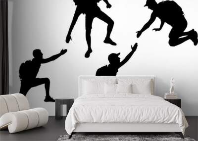 Silhouette of a male climber offering a helping hand to his partner. Business Concept Wall mural