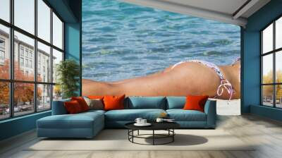 girl in bikini lying on sandy beac Wall mural