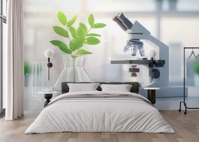 A modern laboratory setup featuring a microscope, plant, glassware, and natural light, symbolizing scientific research and discovery. Wall mural