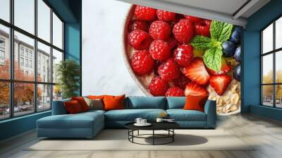 Colorful fruit bowl featuring raspberries, blueberries, and strawberries, perfect for healthy breakfast or snack ideas. Wall mural