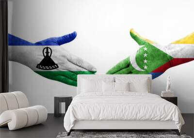 Handshake between Comoros and Lesotho flags painted on hands, isolated transparent image. Wall mural