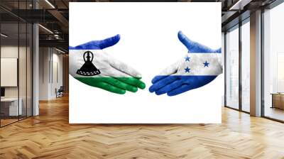 Handshake between Honduras and Lesotho flags painted on hands, isolated transparent image. Wall mural