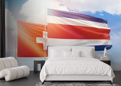 Sunny blue sky and flags of costa rica and switzerland Wall mural