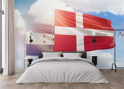 Sunny blue sky and flags of denmark and honduras Wall mural