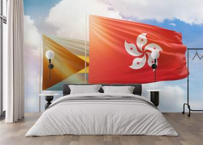 Sunny blue sky and flags of hong kong and bahamas Wall mural