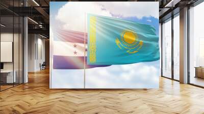 Sunny blue sky and flags of kazakhstan and honduras Wall mural