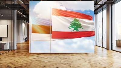 Sunny blue sky and flags of lebanon and estonia Wall mural