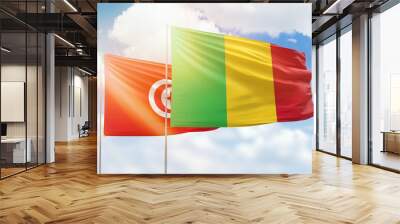 Sunny blue sky and flags of mali and tunisia Wall mural