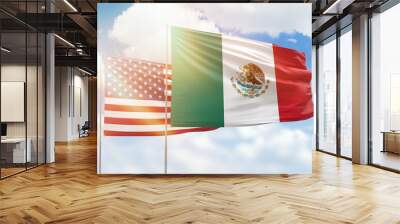 Sunny blue sky and flags of mexico and usa Wall mural