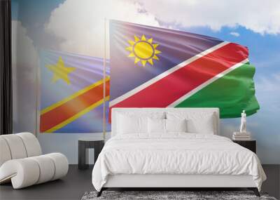 Sunny blue sky and flags of namibia and dr congo Wall mural