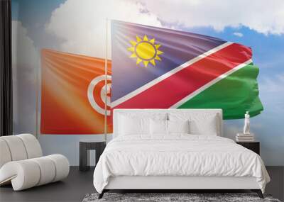 Sunny blue sky and flags of namibia and tunisia Wall mural