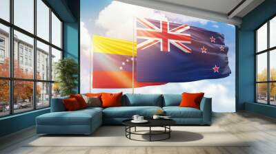 Sunny blue sky and flags of new zealand and venezuela Wall mural