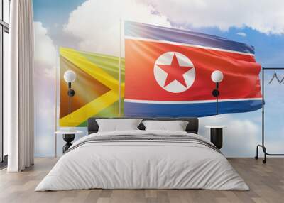 Sunny blue sky and flags of north korea and jamaica Wall mural