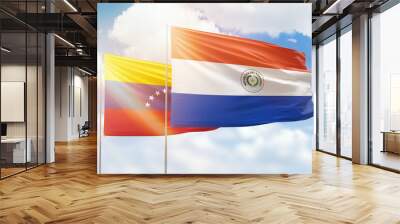 Sunny blue sky and flags of paraguay and venezuela Wall mural