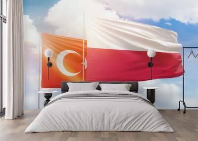 Sunny blue sky and flags of poland and turkey Wall mural