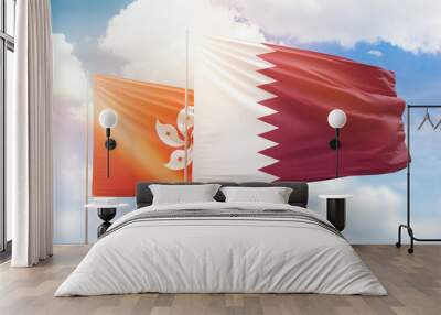 Sunny blue sky and flags of qatar and hong kong Wall mural