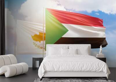 Sunny blue sky and flags of sudan and cyprus Wall mural