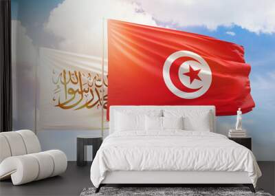 Sunny blue sky and flags of tunisia and afghanistan Wall mural