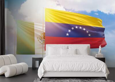 Sunny blue sky and flags of venezuela and mexico Wall mural