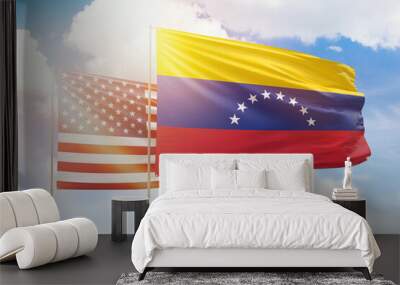 Sunny blue sky and flags of venezuela and usa Wall mural