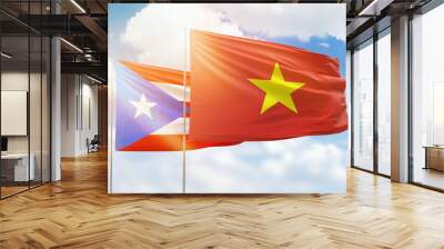 Sunny blue sky and flags of vietnam and puerto rico Wall mural