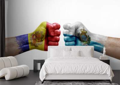 Two hands punch to each others on white background. Country flags painted fists, conflict crisis concept between andorra and san marino Wall mural