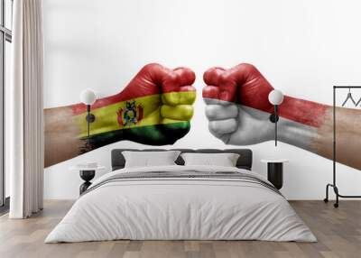 Two hands punch to each others on white background. Country flags painted fists, conflict crisis concept between bolivia and monaco Wall mural