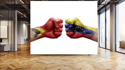 Two hands punch to each others on white background. Country flags painted fists, conflict crisis concept between timor leste and venezuela Wall mural