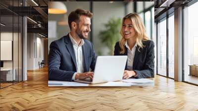 Happy professional business man and woman working on laptop at office meeting, two busy colleagues working together having conversation on project, discussing business plan at office  Wall mural