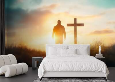 Silhouette of a Man Standing Before a Cross at Sunset Wall mural