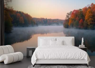 Serene autumn lake with reflections of colorful trees and a gentle mist rising from the water at dawn Wall mural