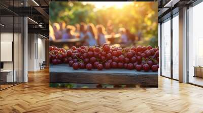 Gooseberries scattered across wooden picnic table at a summer festival with families and children playing in the background evoking joy and community Scientific name Ribes uvacrispa Wall mural