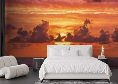 Sunset over ocean with vibrant hues of pink and or Wall mural