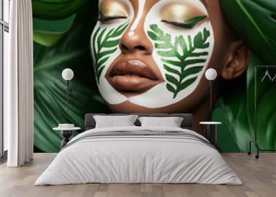 A young woman with green glitter makeup, eyes closed, surrounded by green leaves.  Wall mural