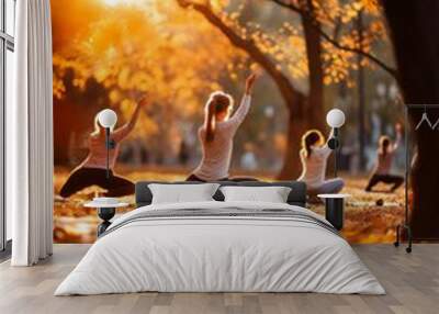 Group of yoga class in a park with autumn leaves, serene and tranquil atmosphere. Wall mural