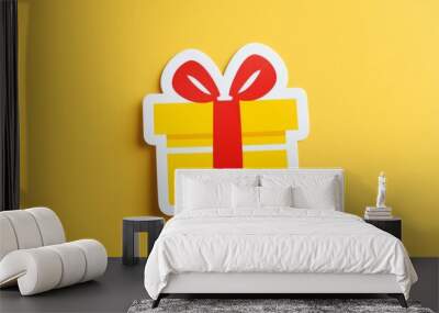 yellow minimal style gift box with ribbons on a vibrant yellow background. Wall mural