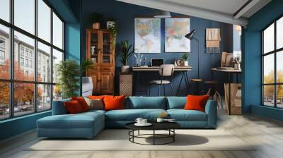 Stylish interior design with retro wooden cabinet, chair, gray sofa, plants, pendant lamp, decoratnion, maps, stool and elegant personal accessories. Modern retro concept of home office space.  Wall mural