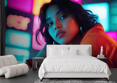 A captivating portrait of a young woman in a vibrant urban setting, showcasing modern fashion and expressive beauty against neon lights. Wall mural