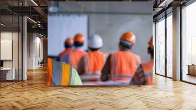 Construction workers in safety gear attending a training session in a classroom setting, focusing on safety protocols and job skills. Wall mural