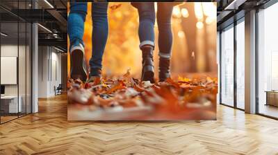 Couple is enjoying a romantic walk in a beautiful autumn park with warm evening light illuminating the colorful foliage Wall mural