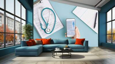 Above view of hands of doctor with gadgets scrolling through medical statistics Wall mural