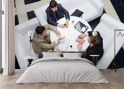 Businesspeople sitting around at the table  Wall mural