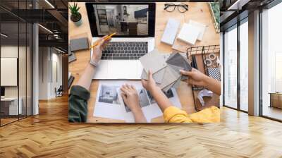 Contemporary designer pointing at home interior example on laptop display Wall mural