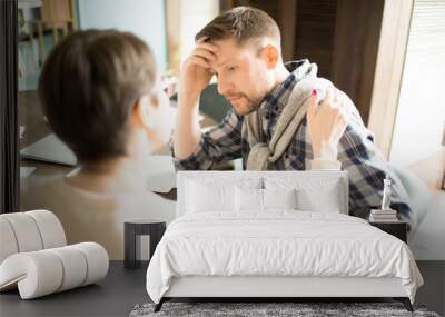 Elegant businesswoman soothing exhausted male colleague while sitting in cozy cafe together.  Wall mural