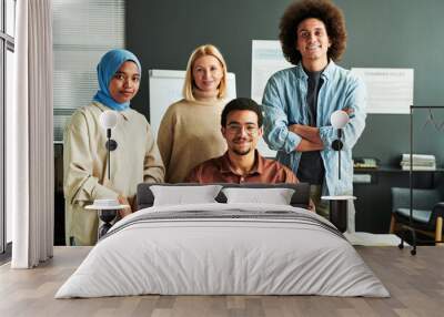 group of multicultural students and mature blond teacher in casual attire standing by desk in front  Wall mural